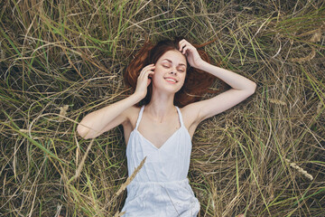 cheerful woman lies on the grass rest lifestyle nature