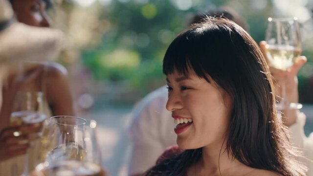 beautiful asian woman dancing with friends at summer dance party drinking wine making toast enjoying summertime social gathering having fun celebrating on sunny day 4k footage