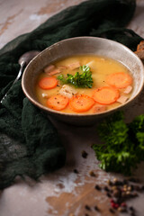 Homemade made split pea soup on beige background and dark green kitchen cloth