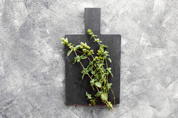 Bunch of fresh thyme leaves on dark grey background