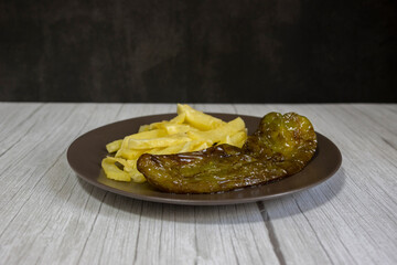 Chips with fried peppers, a very popular food in southern Spain. The potatoes should not be frozen, and all homemade. Made all with olive oil