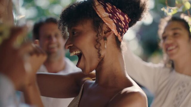 beautiful african american woman dancing with friends at summer dance party drinking wine enjoying summertime social gathering having fun celebrating on sunny day 4k footage