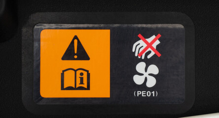 A warning label in a car engine, air compressor. A car maintenance and repair concept. Components...