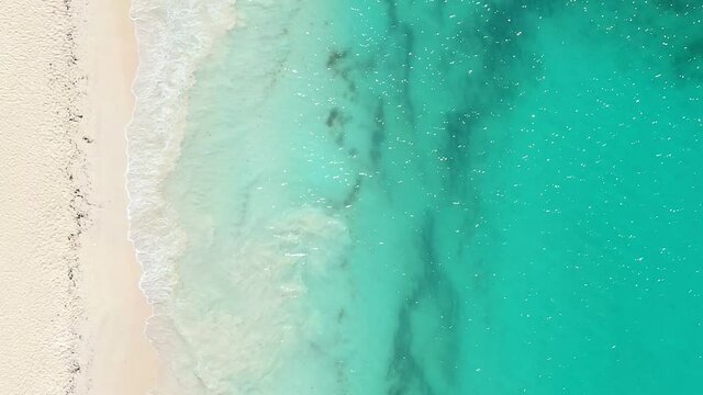 Tropical island and turquoise caribbean sea. Aerial top view. Vertical format video