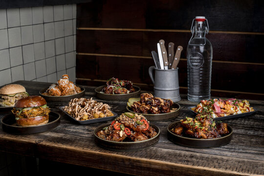 Served table with tasty fast food in restaurant