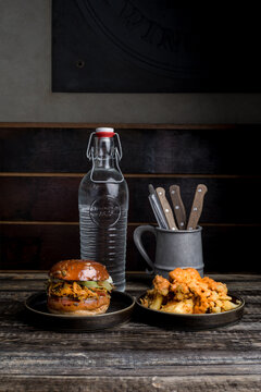 Appetizing burger and crispy chicken placed on table in restaurant