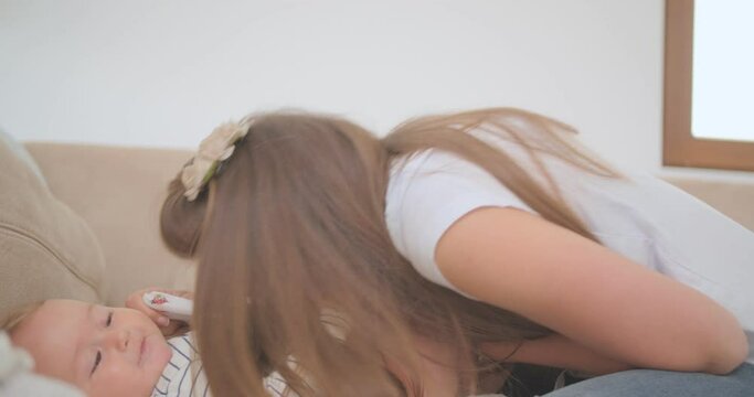 Playing with her stomach to change the diaper