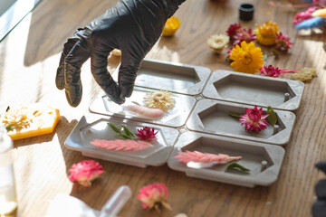 woman businesswoman creates a flavored wax tablet at home. creative profession. how to start making money on a hobby concept.