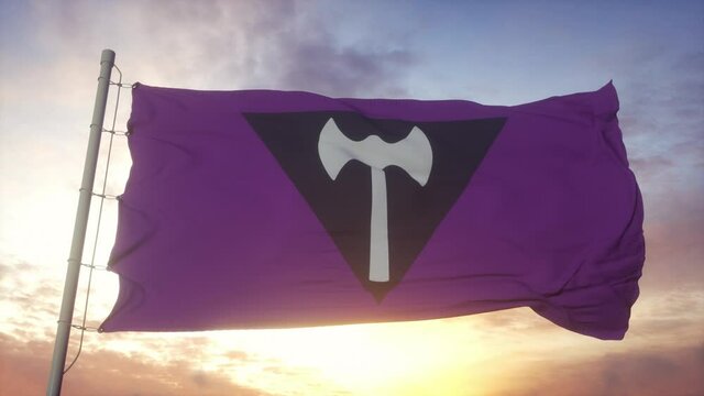 Labrys Lesbian pride flag waving in the wind, sky and sun background