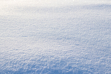 Fototapeta na wymiar Snowy background, snowy surface with a clearly expressed texture of snow in the morning sun