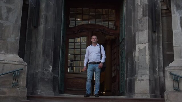 Portrait of handsome man in front of Lviv's Cathedral