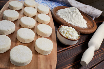 raw cottage cheese pancakes on the wooden board
