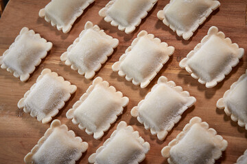 raw dumplings on teh wooden board