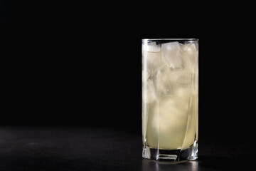 reshly squeezed lemonade with mint in a tall glass with ice.