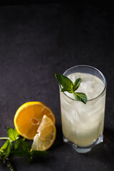 reshly squeezed lemonade with mint in a tall glass with ice.