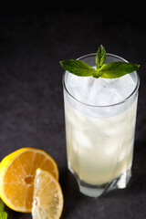 reshly squeezed lemonade with mint in a tall glass with ice.