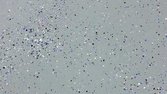 Panning right on the freshly painted garage floor with a gray epoxy finish sprinkled with blue, black and white plastic chips.