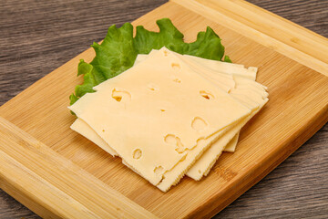 Sliced yellow cheese over board
