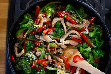 Coocing vegetables in a frying pan. Broccoli, carrots, string beans on cast iron frying pan. Vegetarian Food.