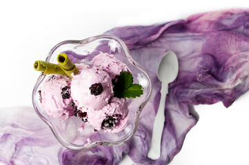 Blueberry ice cream with fresh fruits in a glass cup isolated on white