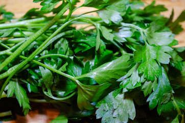 green parsley bundle on a wooden cutting board herb close up macro