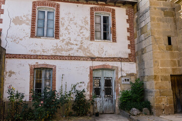 Facade and door of an old abandoned house in a Spanish village