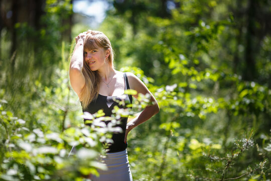beautiful girl stands in thicket of forest