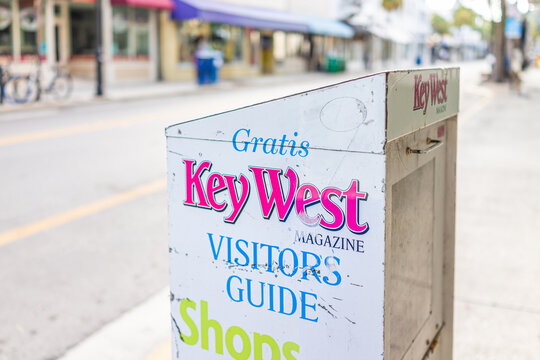 Key West, USA - January 25, 2021: Sign for automatic stand, street dispenser for Gratis Key West magazine visitors guide to stores, shops and shopping in Florida tropical city