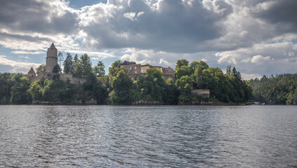 castle ruins on a rock above the dam