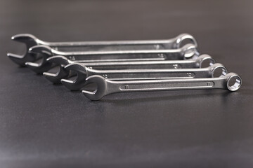 Nut metal wrench on dark background.