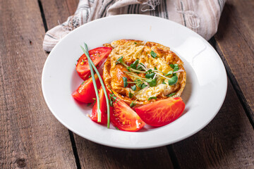 omelet with vegetables fresh breakfast fried eggs and tomato, cucumber fresh portion ready to eat meal snack on the table copy space food background rustic keto or paleo diet veggie 