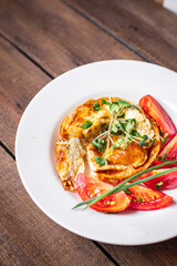 omelet with vegetables fresh breakfast fried eggs and tomato, cucumber fresh portion ready to eat meal snack on the table copy space food background rustic keto or paleo diet veggie 