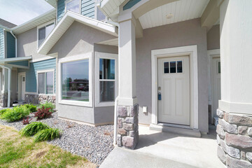 Townhouse exterior with white front door and bay windows