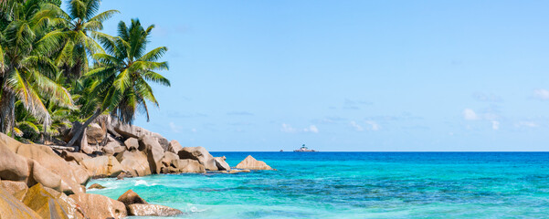 Beach panorama with palm trees, Praslin, Seychelles