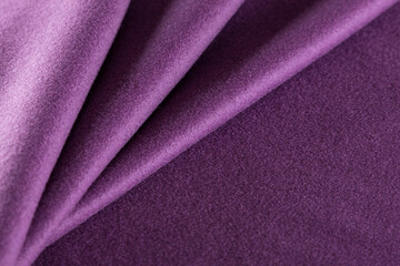 neatly folded warm overcoat fabric with a purple pile