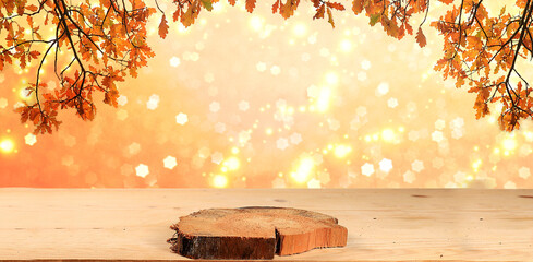 Autumn abstract composition with oak leaves on blurred bokeh background and empty wooden table for...