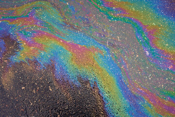 Marbling abstract background from motor oil, gas or petrol spilled on asphalt