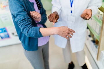 Fototapeta premium Woman shows pharmacist a skin problem she has.
