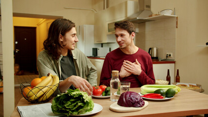 One of friends is patting on the shoulder his pal during conversation