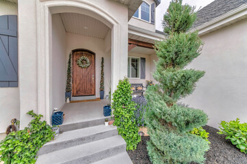 Inviting entrance path of a house with decorated wooden front door