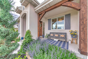 Beautiful front porch of a house with ornamental flowers and plants