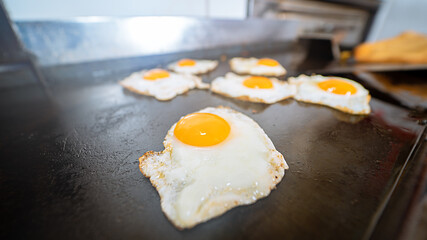 Closeup shot of sunny side up eggs on the stove