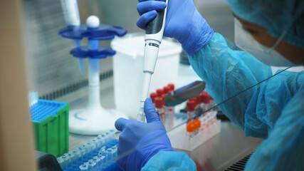 Female biological laboratory researcher working on biomedical experiments. Scientific genetics...