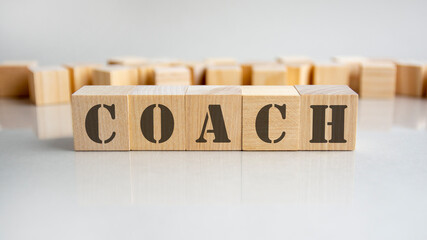 coach text on a wooden blocks, gray background