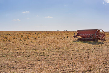 Fototapeta premium Grain seeder direct sowing system in field. Copy space