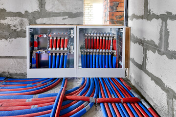 Heating system manifold valves for heat flooring and water supply in a country house. Pipes...