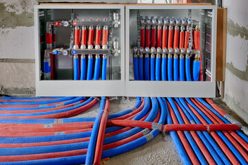 Heating system manifold valves for heat flooring and water supply in a country house. Pipes...