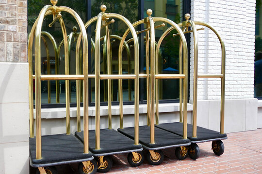 brass luggage caddy in front of luxury resort hotel