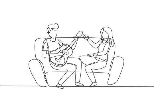 Single one line drawing couple together in love. Boy is playing guitar to his girlfriend in living room on sofa. Girl listen and singing together. Modern continuous line draw design graphic vector