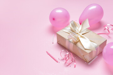 Gift box, balloons and candles on color background, closeup